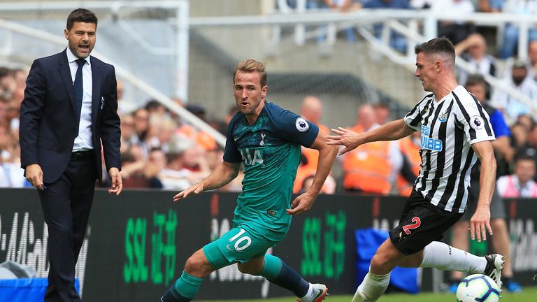 Harry Kane looks to get clear of Ciaran Clark as Mauricio Pochettino looks on