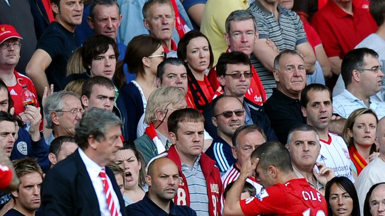 Joe Cole walks past manager Roy Hodgson after being sent off for Liverpool against Arsenal at Anfield in 2010