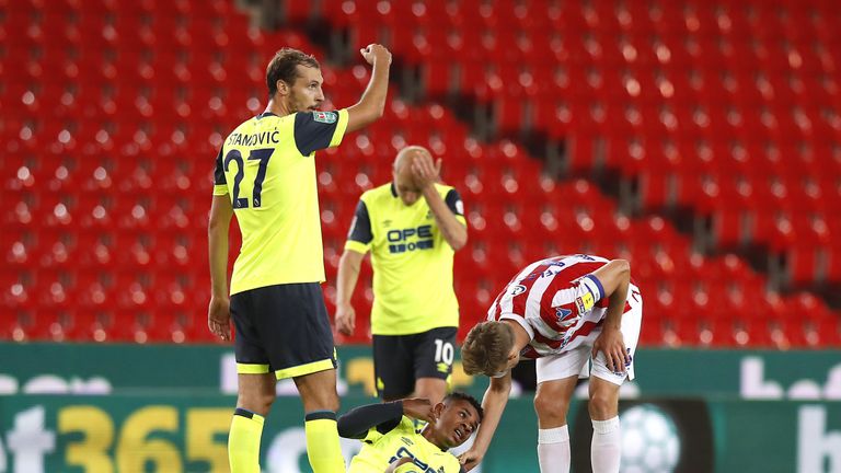 Huddersfield Town's Juninho Bacuna (centre) appears dejected on the ground after scoring an own goal during the Carabao Cup, second round match at the Bet365 Stadium, Stoke.