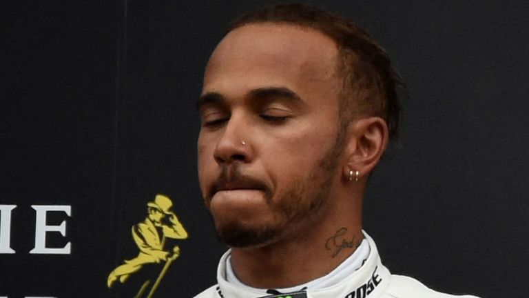Winner Ferrari's German driver Sebastian Vettel celebrates on the podium next to second placed Mercedes' British driver Lewis Hamilton after the Belgian Formula One Grand Prix at the Spa-Francorchamps circuit in Spa on August 26, 2018. 