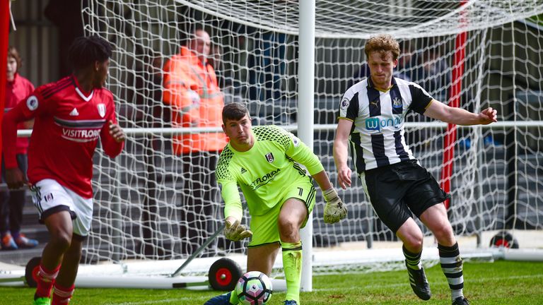 Fulham Goalkeeper Magnus Norman rolls the ball into play under pressure from Tom Heardman of Newcastle on April 10, 2017