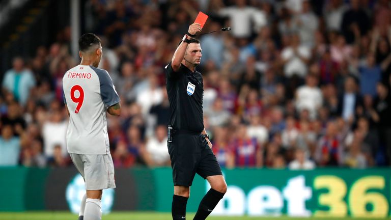 Michael Oliver shows Aaron Wan-Bissaka a red card during Crystal Palace v Liverpool