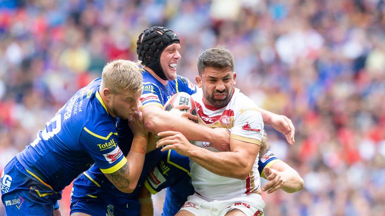 Catalans' Mickael Simon is tackled by Warrington's Mike Cooper & Chris Hill.