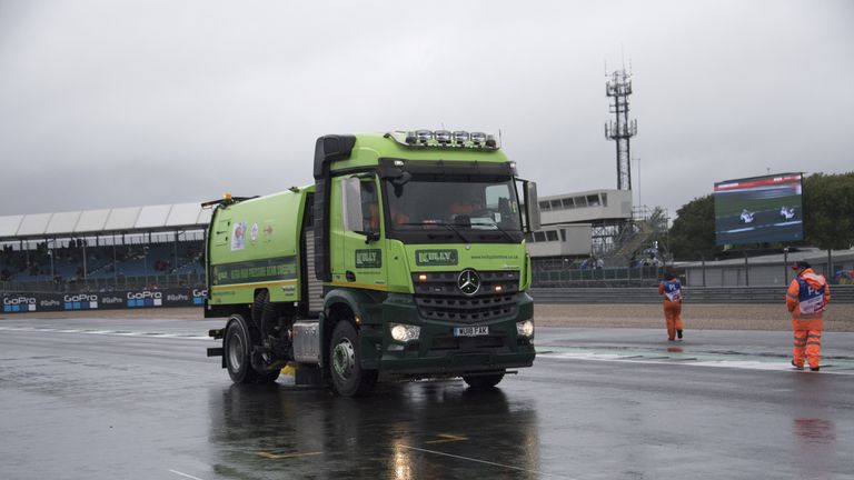 The marshall staff try to clean and dry the track before the start of the British Grand Prix