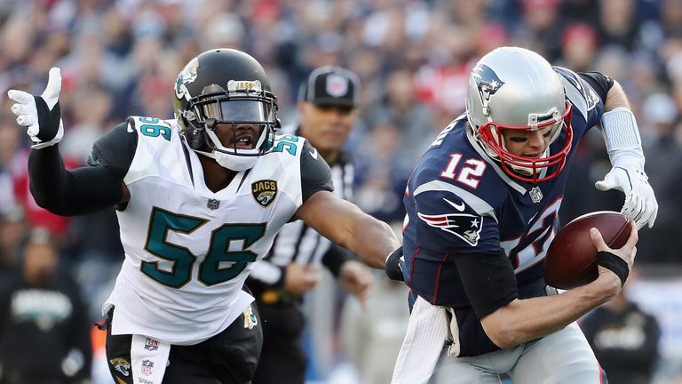 FOXBOROUGH, MA - JANUARY 21:  Tom Brady #12 of the New England Patriots is pursued by Dante Fowler Jr. #56 of the Jacksonville Jaguars in the first quarter during the AFC Championship Game at Gillette Stadium on January 21, 2018 in Foxborough, Massachusetts.  (Photo by Elsa/Getty Images)