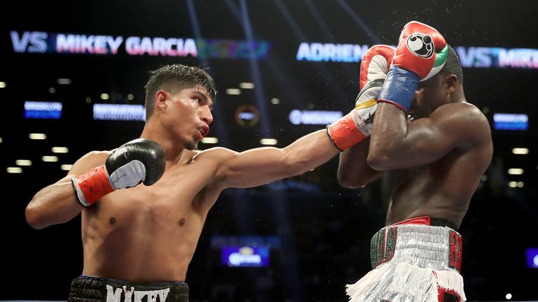 Mikey Garcia punches Adrien Broner during their Junior Welterwight bout on July 29, 2017 at the Barclays Center in the Brooklyn borough of  New York City.  