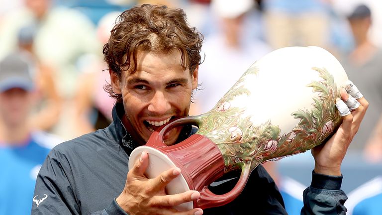 Rafael Nadal poses for photographers with the winners trophy after defeating John Isner during the final of the Western & Southern Open on August 18, 2013 at Lindner Family Tennis Center in Cincinnati, Ohio.