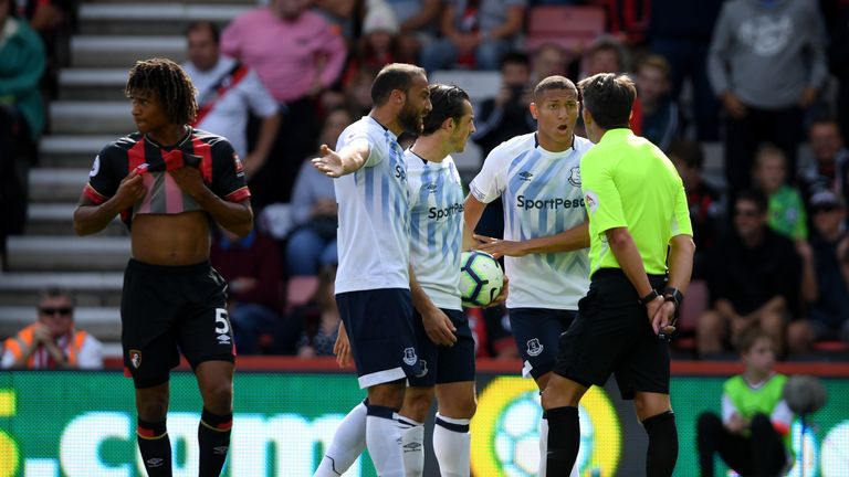 Richarlison protests his innocence after being shown a red card by referee Lee Probert