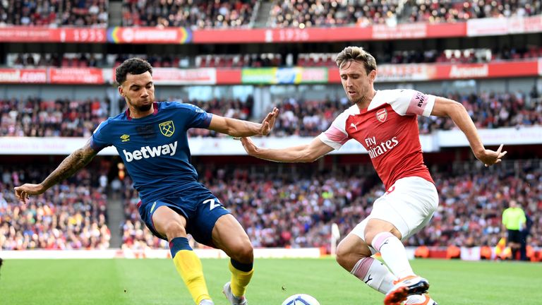 Ryan Fredericks of West Ham United and Nacho Monreal of Arsenal battle for the ball during the Premier League match between Arsenal FC and West Ham United at Emirates Stadium on August 25, 2018 in London, United Kingdom.