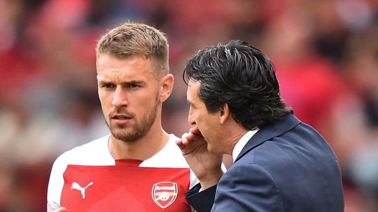 Unai Emery speaks with Aaron Ramsey during the Premier League match against Manchester City