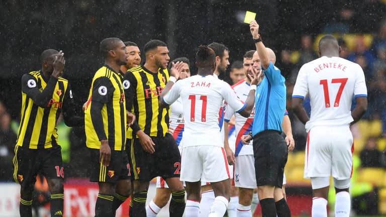 Wilfried Zaha is shown a yellow card at Watford