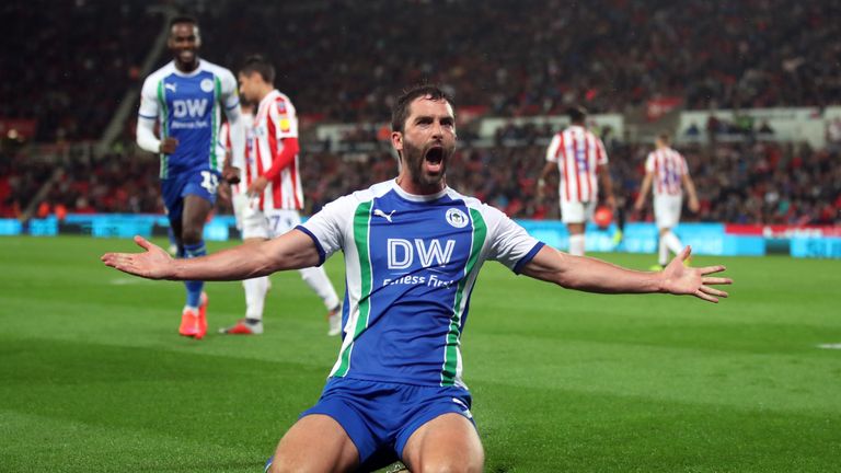 Will Grigg celebrates scoring Wigan's third against Stoke