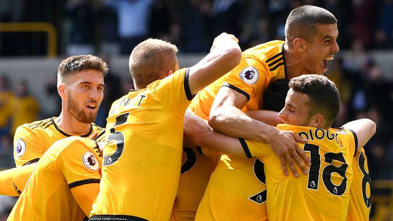 Willy Boly of Wolverhampton Wanderers celebrates after scoring his team's first goal with team mates during the Premier League match between Wolverhampton Wanderers and Manchester City at Molineux on August 25, 2018 in Wolverhampton, United Kingdom. 