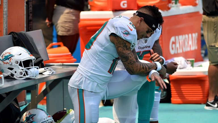 Albert Wilson kneels during the national anthem