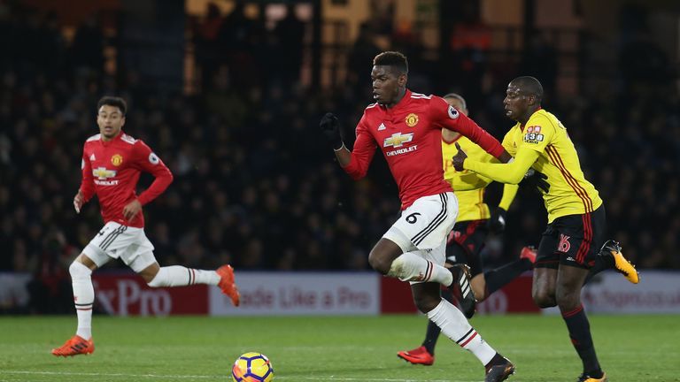 Paul Pogba of Manchester United in action with Abdoulaye Doucoure of Watford during the Premier League match between Watford and Manchester United at Vicarage Road on November 28, 2017 in Watford, England.
