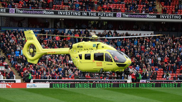 The Yorkshire Air Ambulance lands on the pitch prior to the Sky Bet League One match between Barnsley and Burton Albion at Oakwell due to a medical emergency