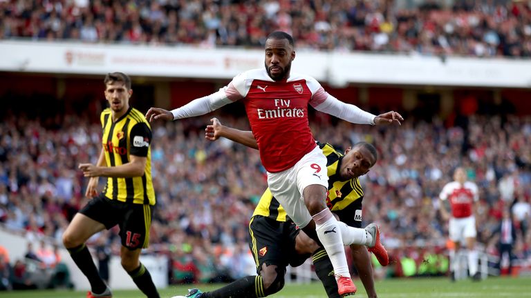 Alexandre Lacazette is challenged in the Watford penalty area