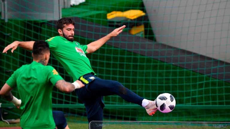 Alisson and Ederson playing football over a table-tennis table during training for Brazil