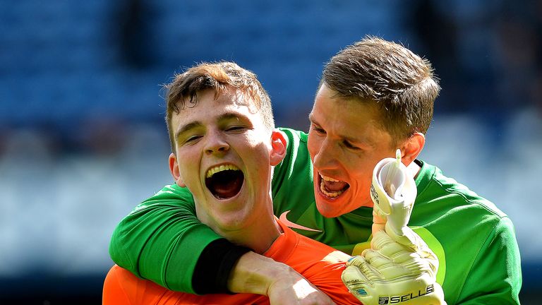 GLASGOW, SCOTLAND - APRIL 12 :Andrew Robertson   of Dundee United celebrates with team mate Radoslaw Cierzniak as Dundee United win the William Hill Scottish Cup Semi Final between Rangers and Dundee United at Ibrox Stadium on April 12, 2014 in Glasgow, Scotland. (Photo by Mark Runnacles/Getty Images)