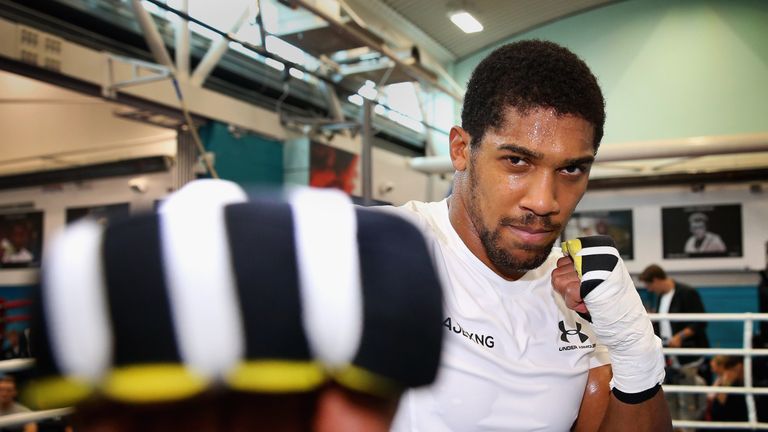 Anthony Joshua poses for a photograph in the ring during a media workout at the English Institute of Sport