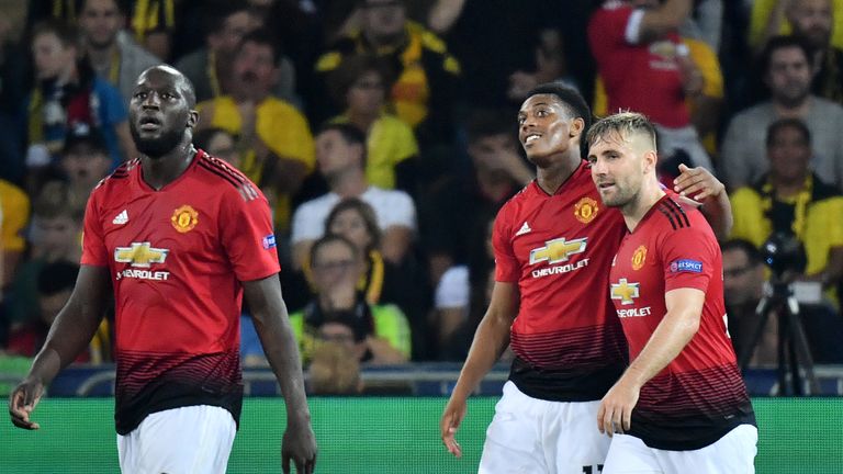 Manchester United's French striker Anthony Martial (C) celebrates after scoring with teammates Romelu Lukaku (L) and Luke Shaw (R) during the UEFA Champions League group H football match between Young Boys and Manchester United at The Stade de Suisse in Bern on September 19, 2018