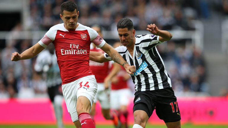 Granit Xhaka challenges for the ball with Ayoze Perez