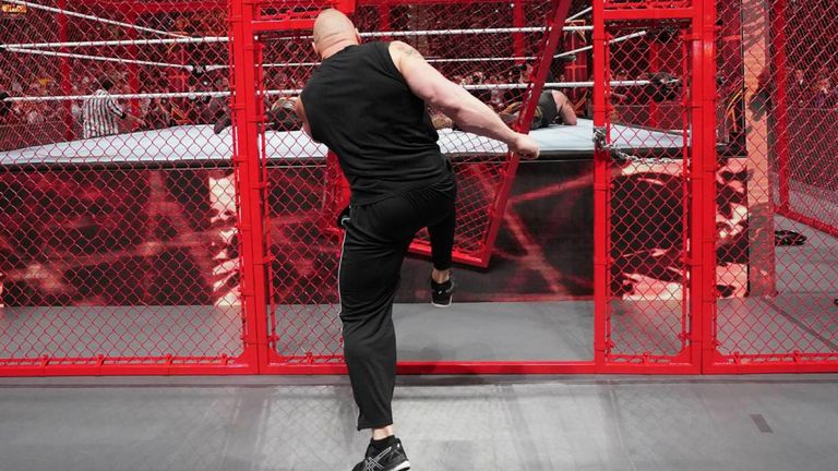 brock lesnar smashes through hell in a cell door