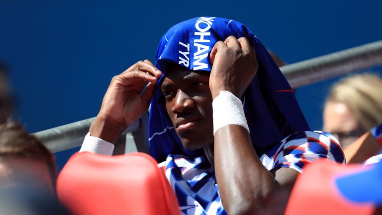 Chelsea's Tammy Abraham shelters from the sun on the bench during the Community Shield match against Manchester City