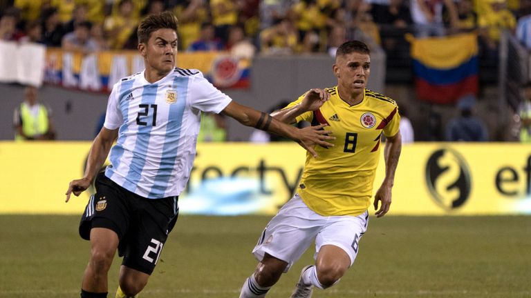Paulo Dybala (L) vies for the ball with Colombia midfielder Gustavo Cuellar