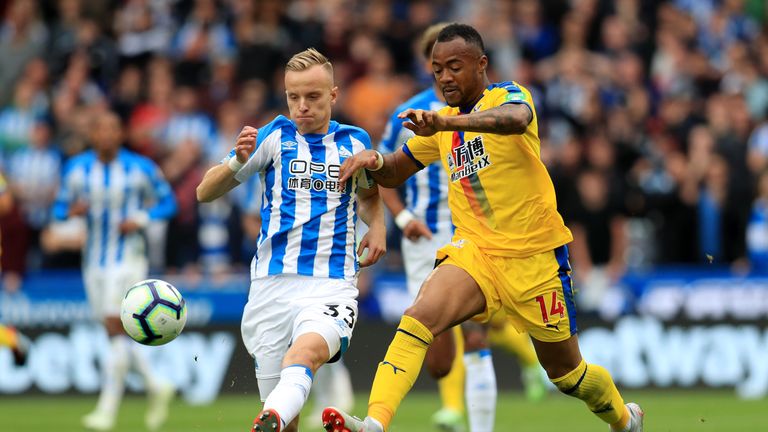 Huddersfield Town's Florent Hadergjonaj (left) and Crystal Palace's Jordan Ayew battle for the ball 