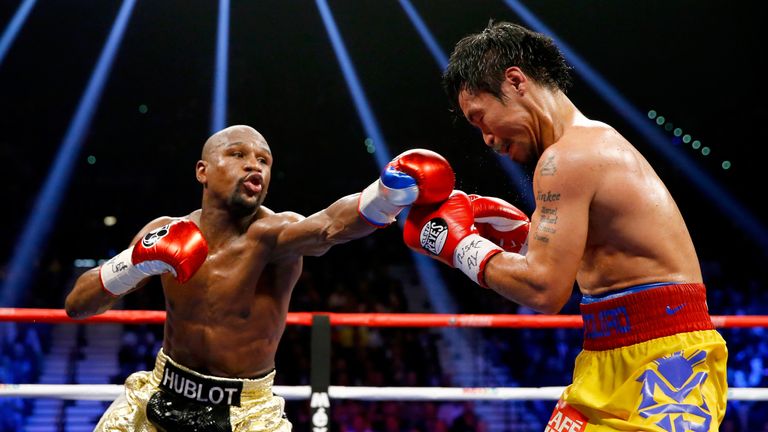 Floyd Mayweather Jr. throws a right at Manny Pacquiao during their welterweight unification championship bout on May 2, 2015 at MGM Grand Garden Arena in Las Vegas, Nevada. 