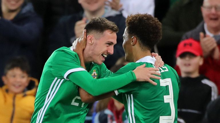 Northern Ireland's Gavin Whyte (left) celebrates scoring his side's third goal of the game during the International Friendly at Windsor Park, Belfast