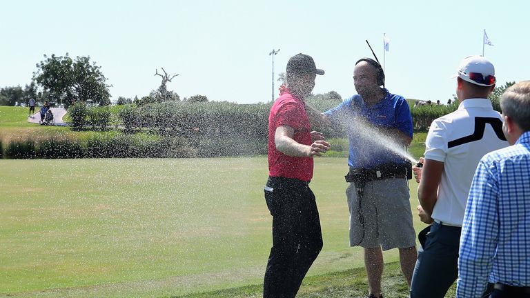 Oliver Fisher is sprayed with champagne by Matt Wallace after shooting 59