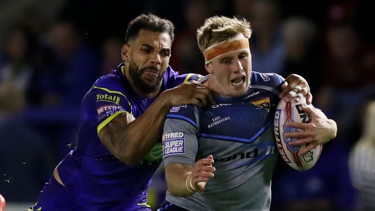 Adam O'Brien of Huddersfield Giants is tackled by Ryan Atkins of Warrington Wolves