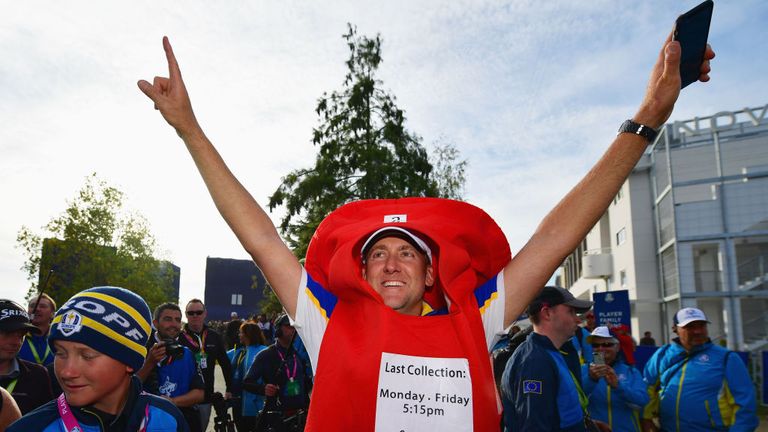 PARIS, FRANCE - SEPTEMBER 30:  Ian Poulter of Europe celebrates winning The Ryder Cup after taking a Post Box outfitt off of a fan during singles matches of the 2018 Ryder Cup at Le Golf National on September 30, 2018 in Paris, France.  (Photo by Stuart Franklin/Getty Images)