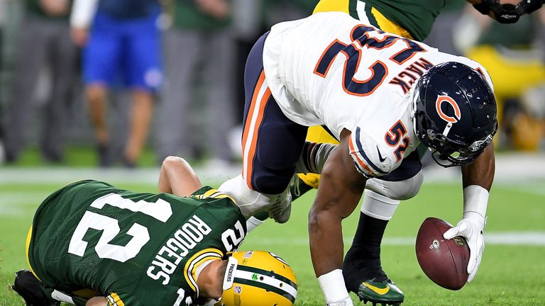 Khalil Mack scoops up the ball for Chicago as Aaron Rodgers lays injured