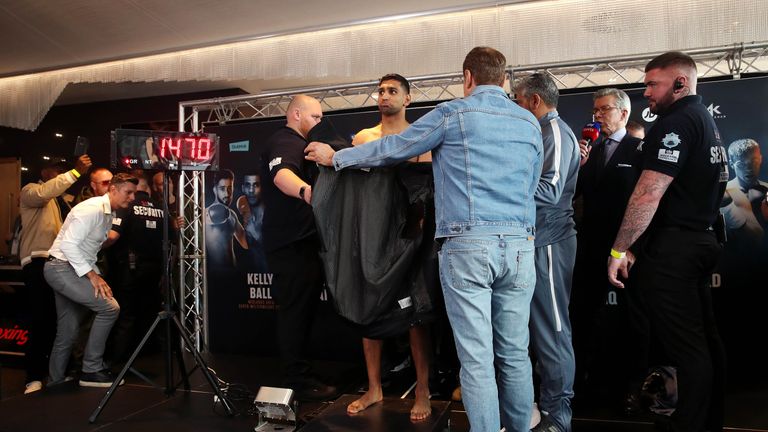 Amir Khan (centre) during the weigh in at Arena Birmingham.