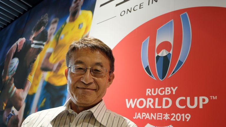 Koji Tokumasu, senior director of the World Cup organising committee and former Asia Rugby boss, posing with the logo of the 2019 Rugby World Cup, in Tokyo