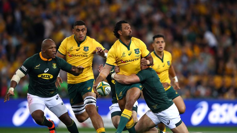 Australia's Kurtley Beale offloads the ball in the tackle