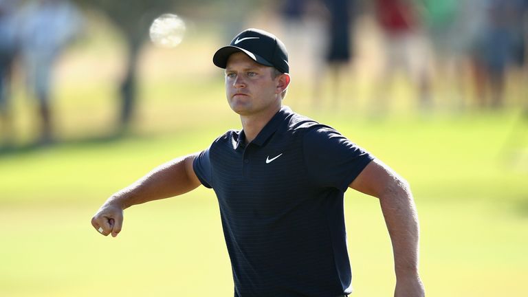 Tom Lewis celebrates his par save at the par-five 17th having found water off the tee