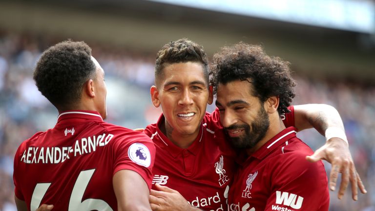 Liverpool's Roberto Firmino (centre) celebrates scoring his side's first goal of the game during the Premier League match at Wembley Stadium, London