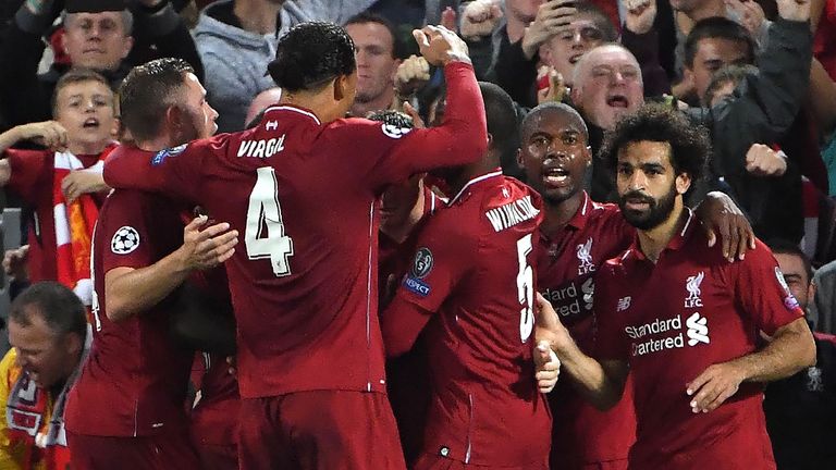 Liverpool's English midfielder James Milner celebrates with teammates after scoring a penalty during the UEFA Champions League group C football match between Liverpool and Paris Saint-Germain at Anfield in Liverpool, north west England on September 18, 2018