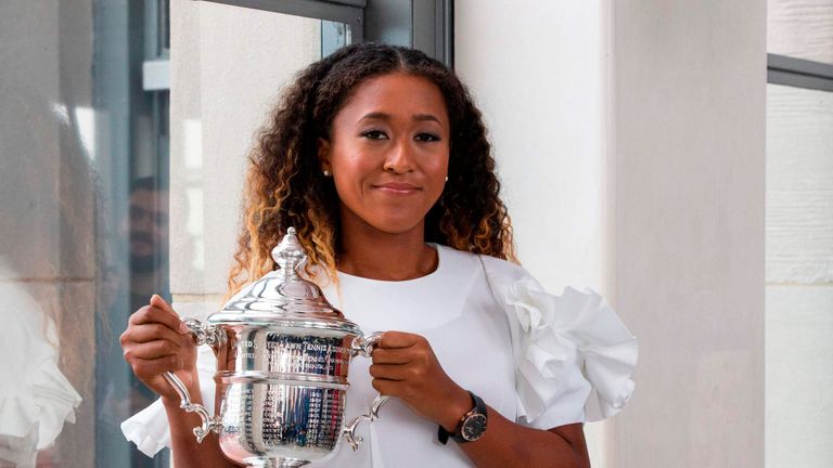 Naomi Osaka of Japan poses with her championship trophy at the Rock Observation Deck at Rockefeller Center in New York on September 09, 2018, the morning after defeating Serena Williams of the United States, winning the 2018 US Open Women&#39;s Singles Finals.
