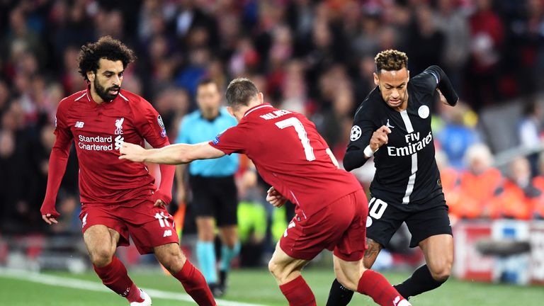 Neymar of Paris Saint-Germain is challenged by James Milner of Liverpool during the Group C match of the UEFA Champions League between Liverpool and Paris Saint-Germain at Anfield on September 18, 2018 in Liverpool, United Kingdom