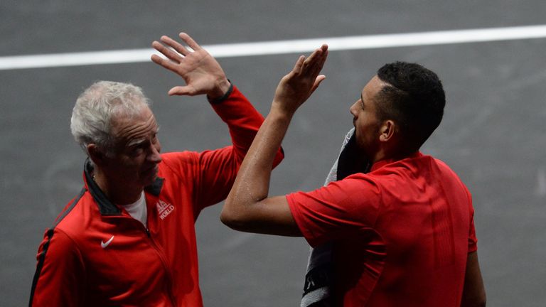 Australian Nick Kyrgios (R) of Team World gives a high five to US John McEnroe, captain of Team World during the Laver Cup on September 23, 2017 in O2 Arena, in Prague