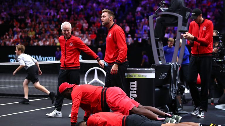Team World Nick Kyrgios of Australia and Team World Frances Tiafoe of the United States do push-ups during the Men's Singles match between Team World Diego Schwartzman of Argentina and Team Europe David Goffin of Belgium on day one of the 2018 Laver Cup at the United Center on September 21, 2018 in Chicago, Illinois.