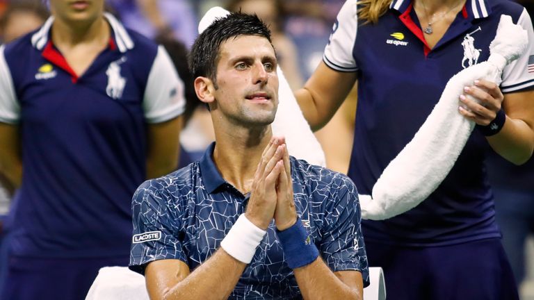 Serbia's Novak Djokovic speaks with people in his box during a changeover in his Men's Singles Quarter-Finals tennis match against Australia's John Millman at the 2018 US Open at the USTA Billie Jean King National Tennis Center in New York on September 5, 2018. 