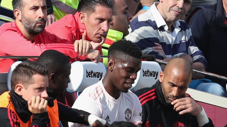 Paul Pogba takes his place on the bench after his substitution