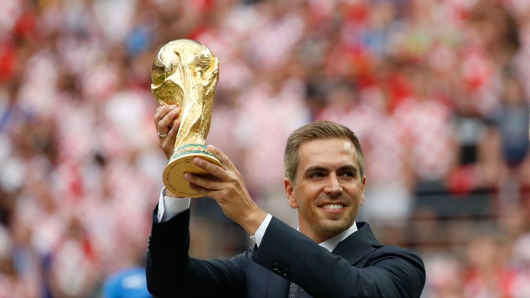 Phillip Lahm poses with the World Cup trophy in Russia