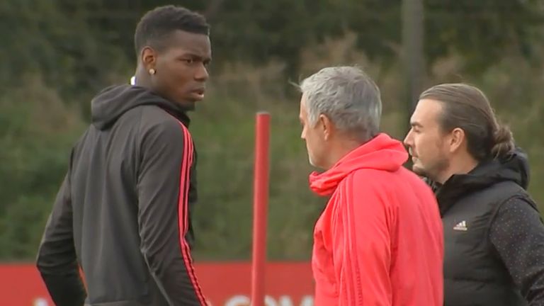 Paul Pogba and Jose Mourinho exchange words during training.